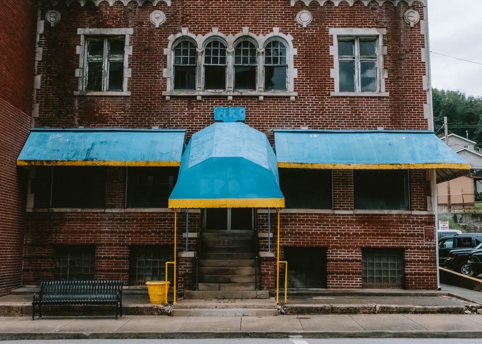 Abandoned apartment building with blue awning