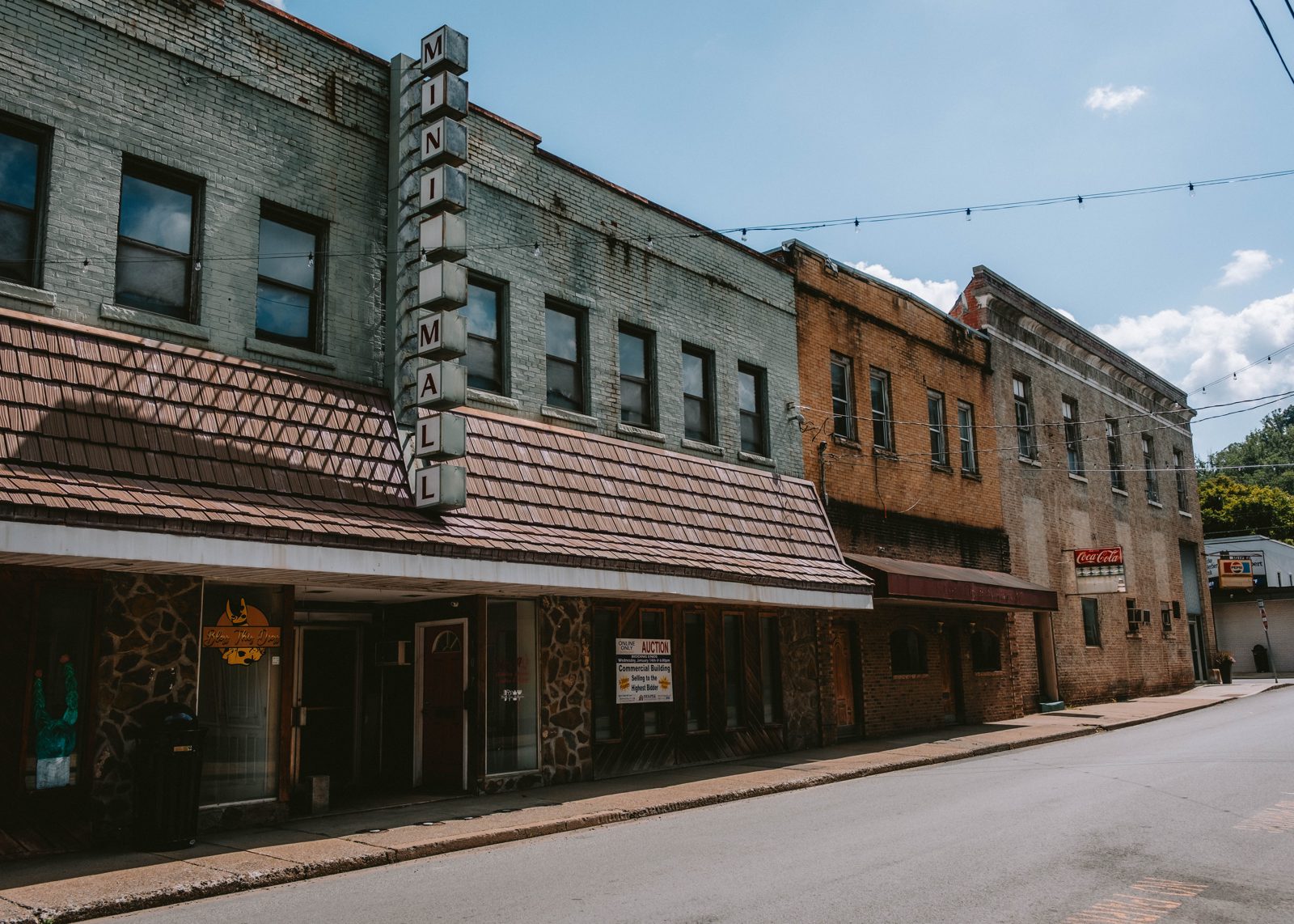 Abandoned small-town mall with sign