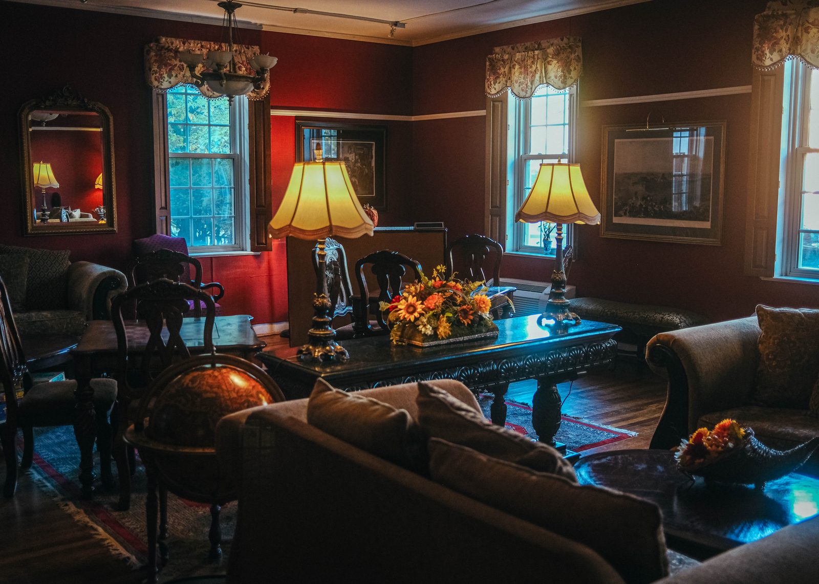 Historic sitting room with lamps and ornate wood