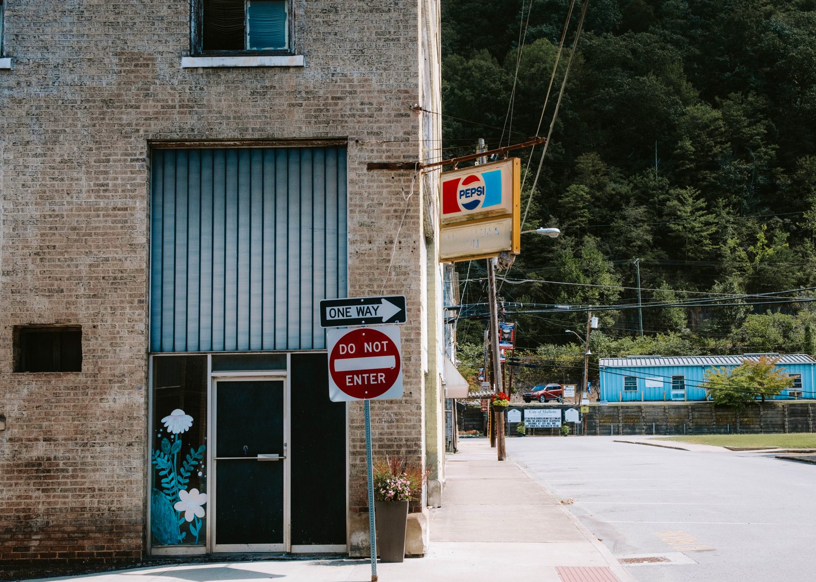 Closed store on quiet street with do not enter sign