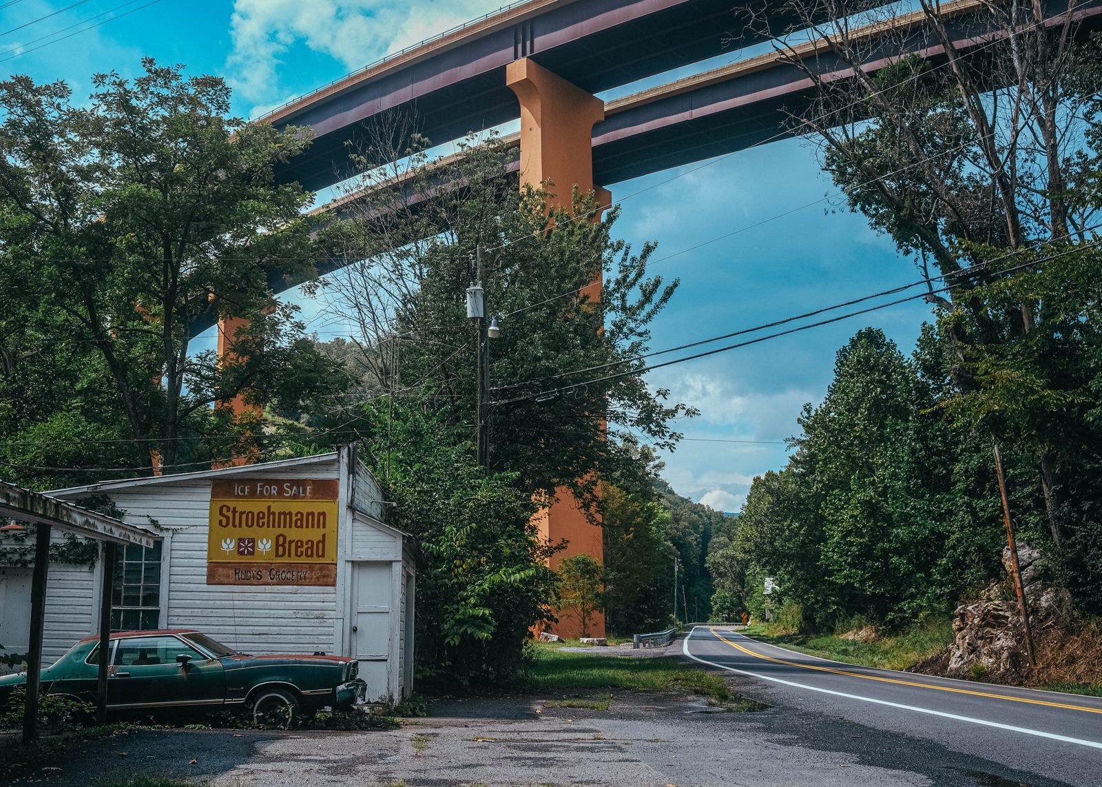 Abandoned store with towering freeway bridge